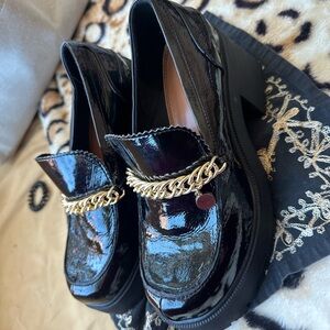 Wide foot patent black platform loafers with gold chain detail